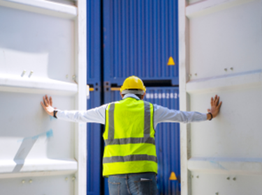 Worker opening shipping container doors