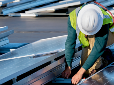 Worker installing a solor panel